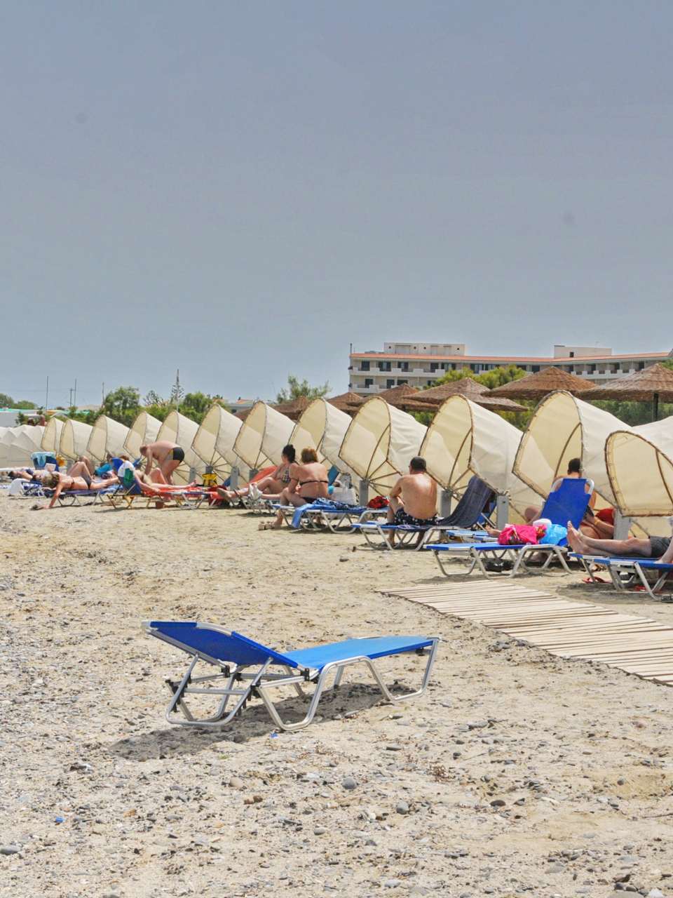 Ein Strand mit einer langen Reihe Liegen